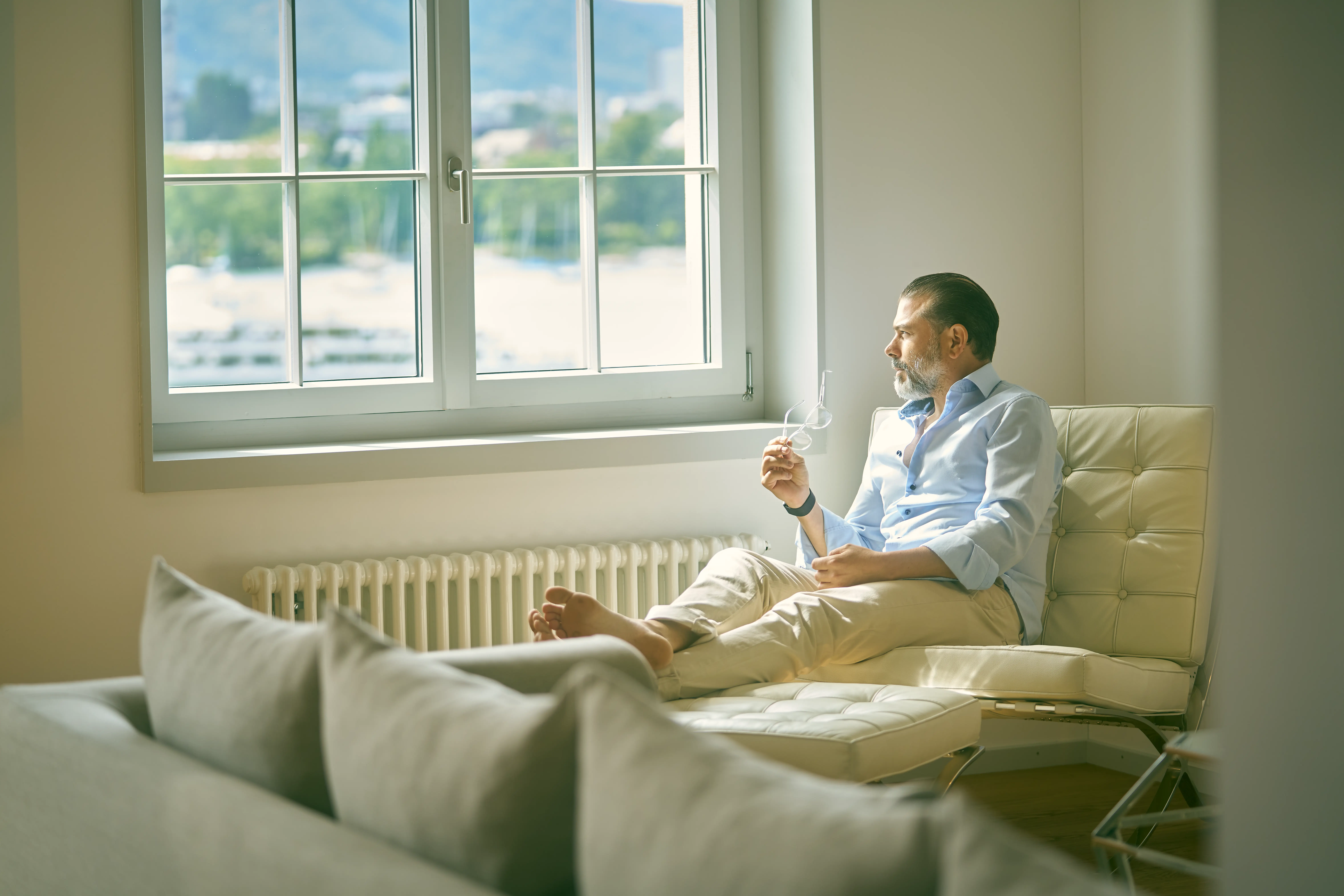 Man relaxing by window at Paracelsus Recovery during probiotic therapy treatment