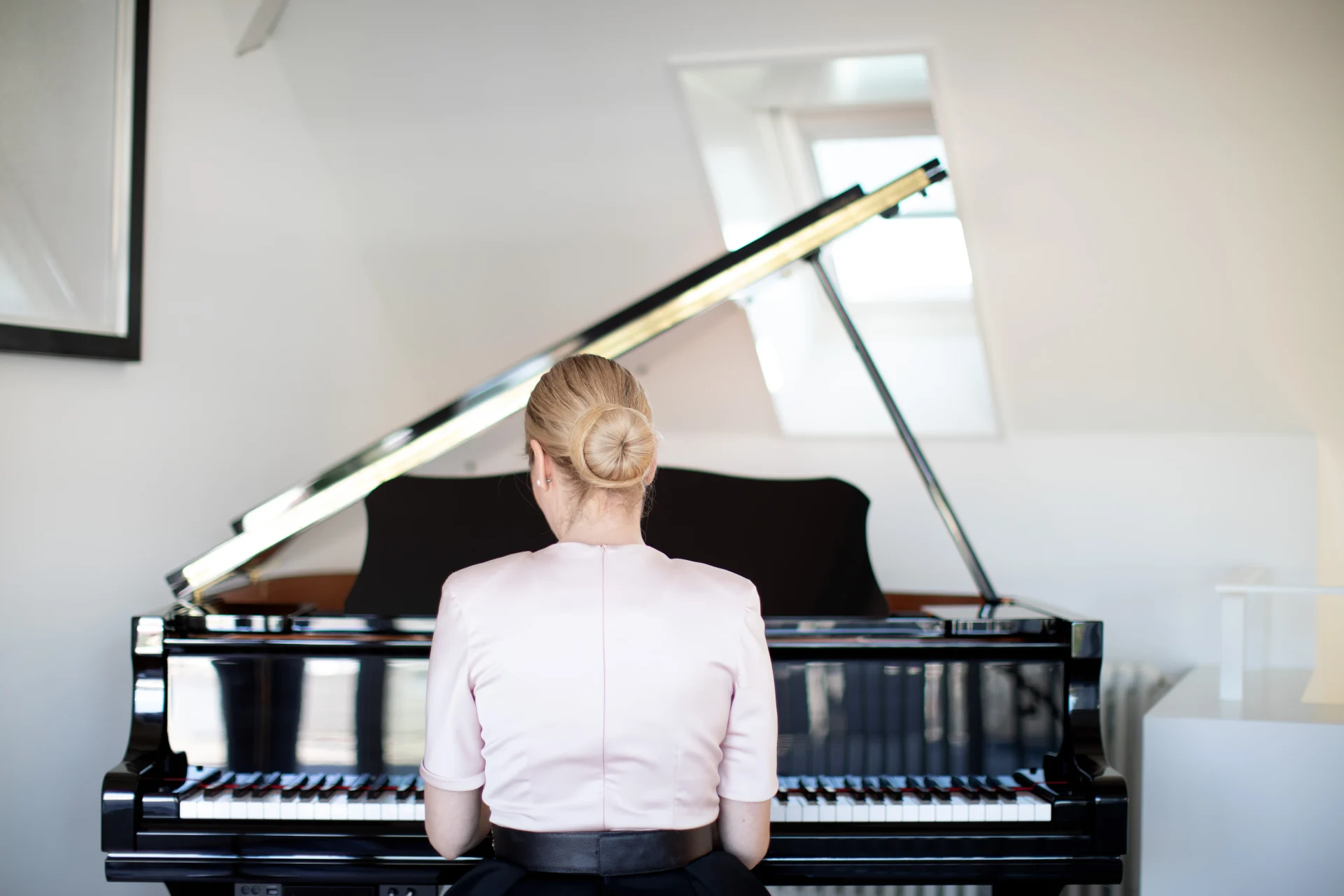 Woman playing piano in the Equilibria residence